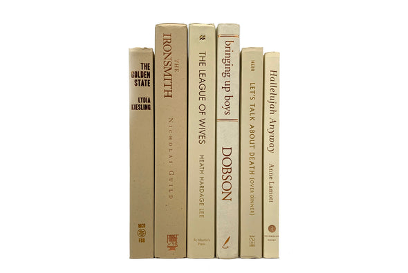 Beige decorative books. Color-coded book stack by the shelf foot.
