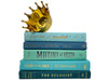 beachy coastal green and blue decorator books. Color-coded book stack by the shelf foot. 