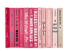 Pink decorator books. Color-coded book stack by the shelf foot.