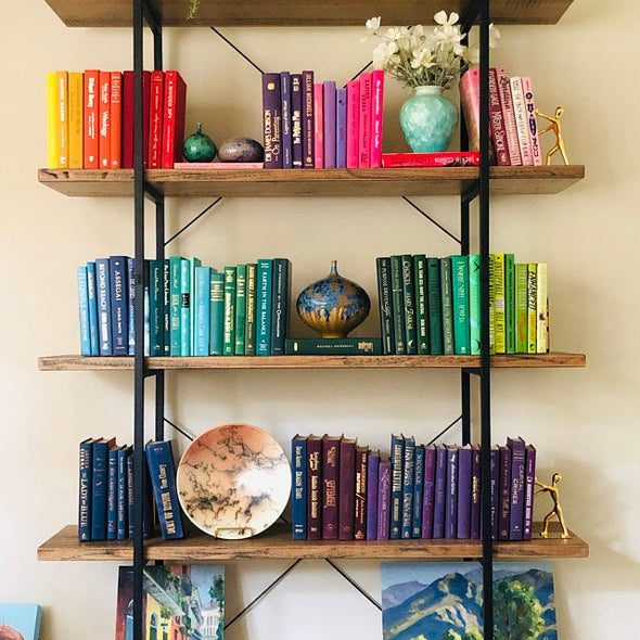 Rainbow  decorator books. Color-coded book stack by the shelf foot.  Edit Your Home Decor.