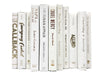 Gold and silver foil lettered white decorator books. Color-coded book stack by the shelf foot