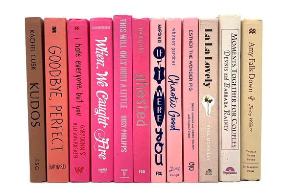 Pink decorator books. Color-coded book stack by the shelf foot. 